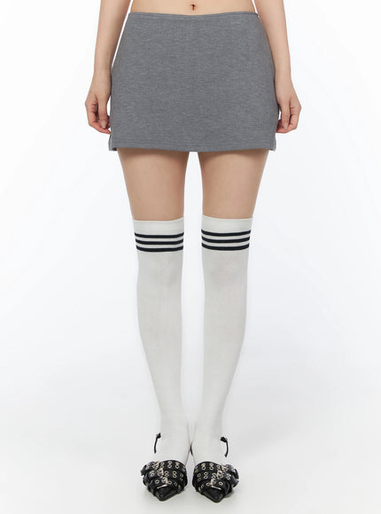 LEWKIN Low-Rise Mini Skort IU525 Gray S/M front close-up on model showing low-rise waistband and heathered cotton mini skirt length with white knee-high socks