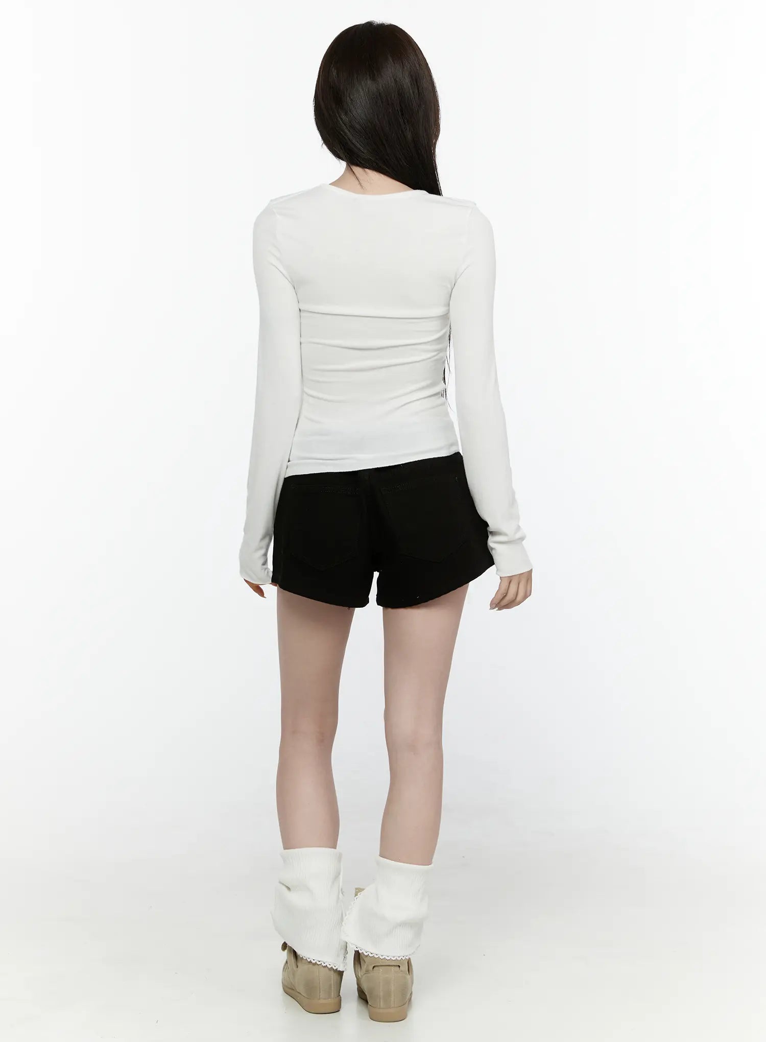 Low Rise Shorts IL521 Black back full-length shot on model wearing white long-sleeve top showing rear denim pocket detail and fitted back rise with leg warmers