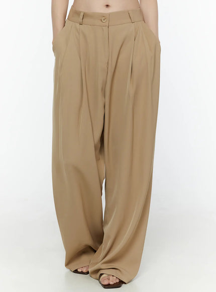 Low-Rise Wide Leg Tailored Pants IL506 Beige front view on model with hands in pockets showing voluminous wide-leg pleat drape and full length