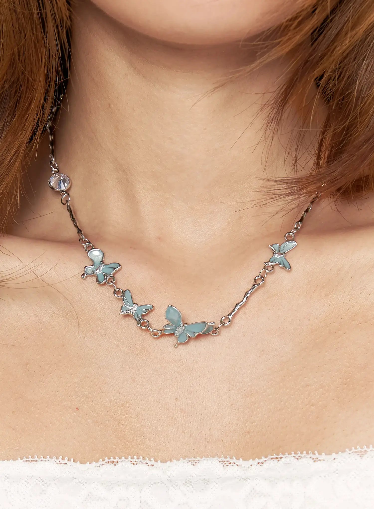 Luna Butterfly Style Necklace IL517 mint blue on-model front view worn on neckline showing full row of enamel butterfly charms on silver chain