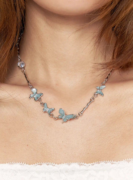 Luna Butterfly Style Necklace IL517 mint blue on-model front view worn on neckline showing full row of enamel butterfly charms on silver chain