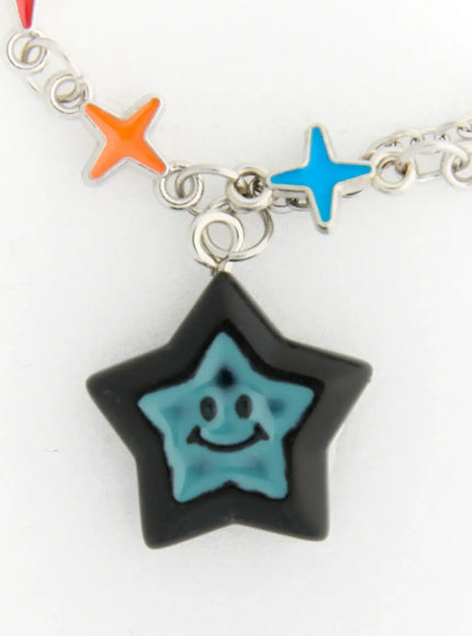 LEWKIN Lyra Star Crystal Necklace IL517 multicolor close-up detail of black and teal smiley star pendant with orange and blue enamel four-pointed star charms on silver chain
