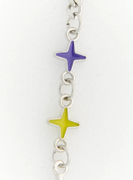 Lyra Star Crystal Necklace IL517 multicolor close-up detail of silver chain section featuring purple and yellow-green enamel four-pointed star charms with rolo links