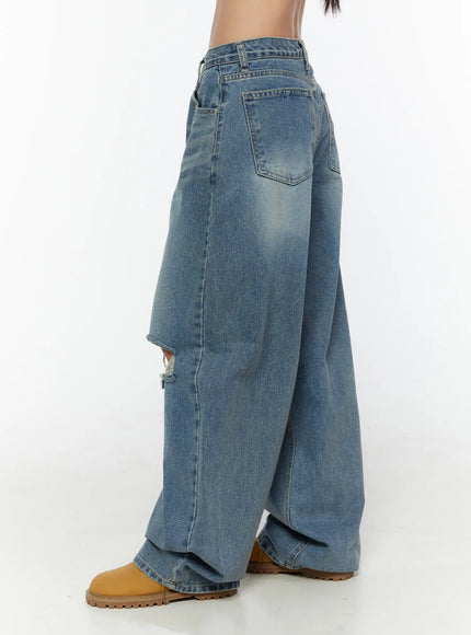 Mackenzie Blue Rip Jeans CU526 Blue side shot on model revealing wide-leg drape, ripped knee detail, back pocket, and faded denim texture