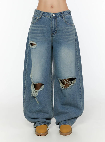 Mackenzie Blue Rip Jeans CU526 Blue front close-up on model showing large ripped knee cutouts and wide-leg silhouette with faded wash