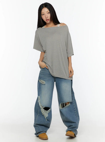 Mackenzie Blue Rip Jeans CU526 Blue full-length front shot on model with striped off-shoulder top, hand in pocket, casual standing pose