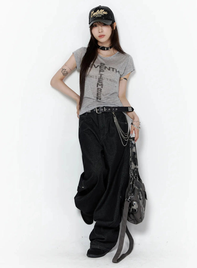 Maelani Rivet Wide Balloon Jeans IL502 Black full-body front shot on model styled with gray graphic tee, chain belt, cap and shoulder bag in edgy street look