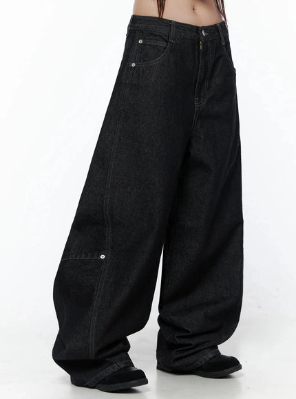 Maelani Rivet Wide Balloon Jeans IL502 Black side-angle waist-to-hem shot on model showing deep front pockets, rivet hardware and extreme balloon leg volume