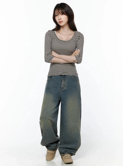 Marion Washed Wide-Leg Jeans IL506 Dark blue full-body front on model arms crossed, wide-leg denim with yellow-tinted wash, pooling hem over beige loafers