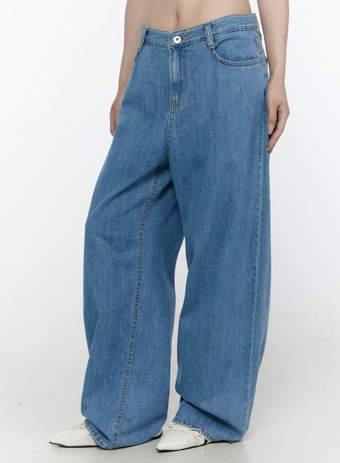 Max Wide Leg Jeans IL521 Blue side view on model showing relaxed wide-leg denim styled with white layered camisole top and black tote bag