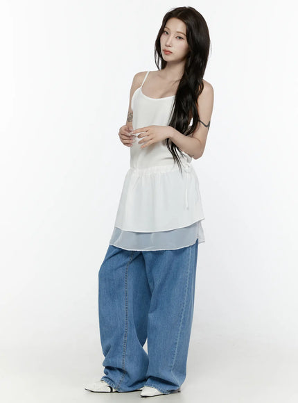Max Wide Leg Jeans IL521 Blue three-quarter front view on model with arms crossed, styled with white ruffle drawstring camisole and white pointed shoes