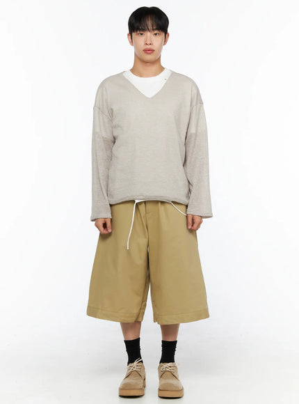 Men's Baggy Bermuda Shorts IL514 Beige front full-length view on model styled with oatmeal waffle knit sweater, drawstring waistband and wide-leg cotton twill