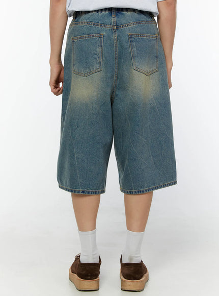 Men's Baggy Fit Jorts IU529 Blue back view on model showing dual back pockets, faded wash with yellow tint, and topstitching detail