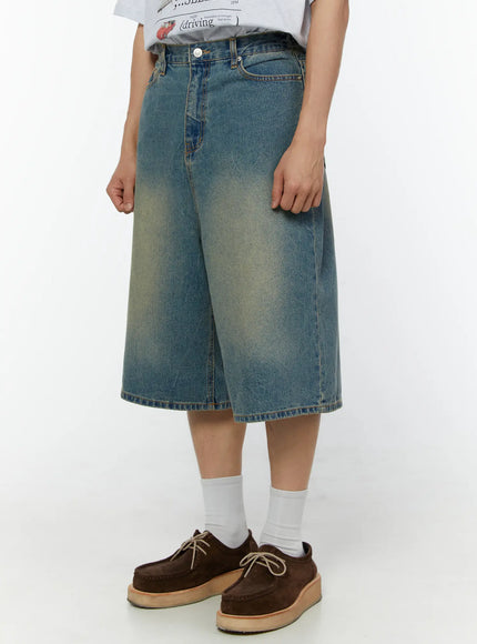 Men's Baggy Fit Jorts IU529 Blue side angle close-up on model showing faded wash texture, belt loops, and wide-leg silhouette with brown moc-toe shoes