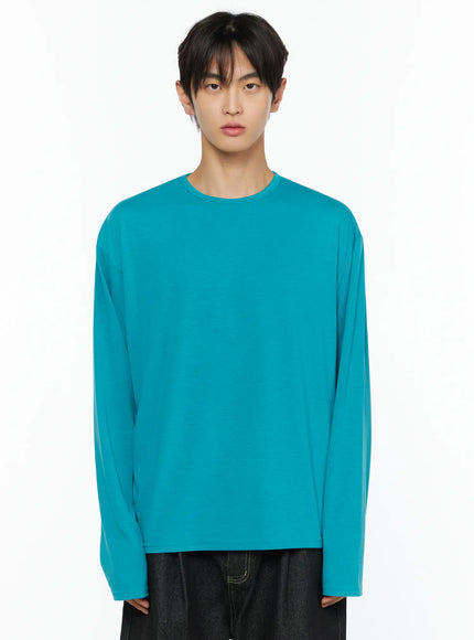 Men's Basic Long Sleeve T-Shirt IL528 Teal close-up front shot on male model showing crew neck and smooth jersey fabric with dropped shoulders