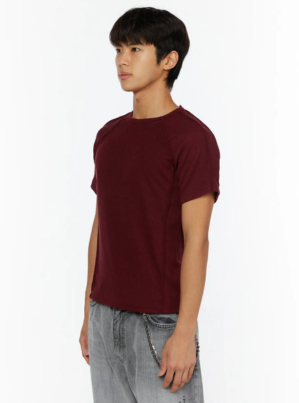 Men's Basic Ribbed T-Shirt IL509 Burgundy side model shot male upper body showing raglan sleeve seam ribbed fabric texture and curved hem detail