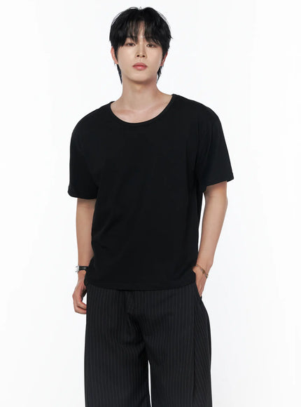 Men's Basic U-Neck T-Shirt IU523 Black front shot on male model standing upright paired with pinstripe wide-leg trousers