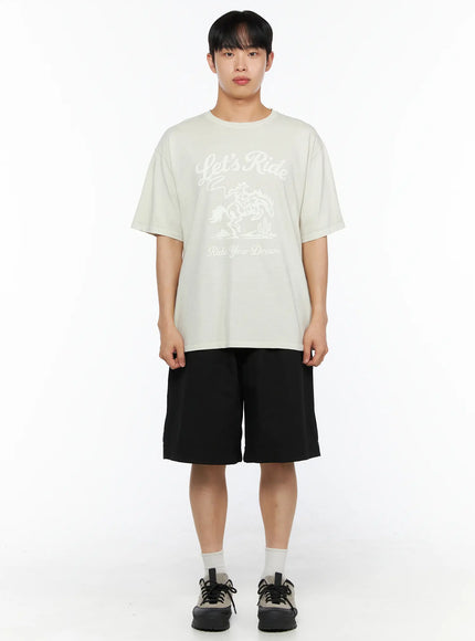 Men's Bermuda Shorts (Black) IL514 black full-body front shot on male model paired with oversized cream Let's Ride graphic tee and chunky sneakers