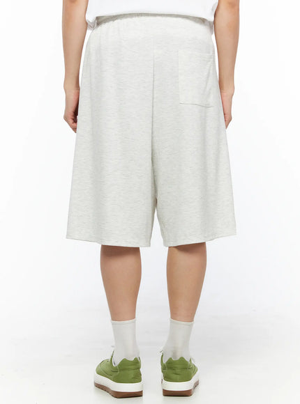 Men's Bermuda Sweat Shorts (Light Gray) IL514 Light gray back shot on model revealing single back patch pocket elastic waistband and wide-leg melange sweat fabric