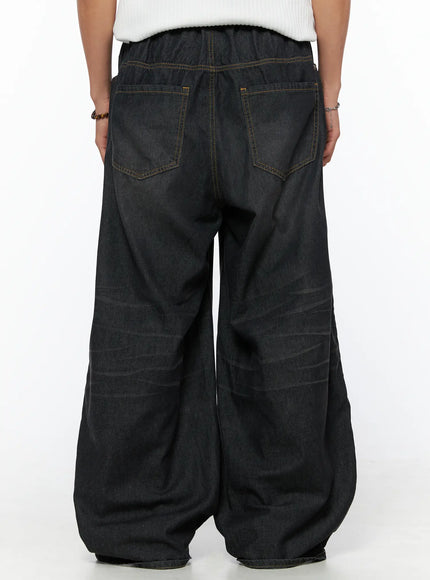 Men's Bryan Drawstring Baggy Jeans IL520 Black back shot on model showing elastic waistband, double back pockets, yellow topstitching, voluminous wide-leg hem