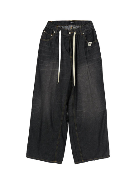 Men's Bryan Drawstring Baggy Jeans IL520 Black flat-lay front view showing elastic waistband, cream drawstring, brand patch, yellow topstitching, wide-leg silhouette