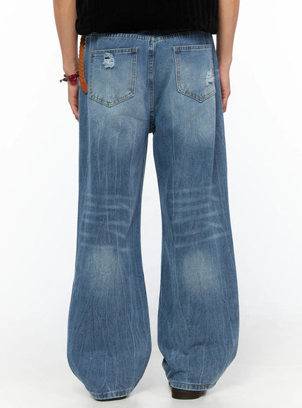 Men's Bryce Ripped Straight-Fit Jeans IL520 Blue back view on model showing dual back pockets whisker fade wide leg hem braided belt brown loafers