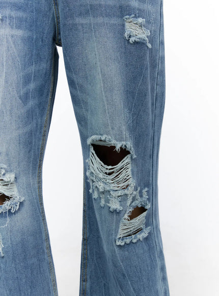 Men's Bryce Ripped Straight-Fit Jeans IL520 Blue close-up detail shot showing large frayed knee rips open holes and washed denim texture no model
