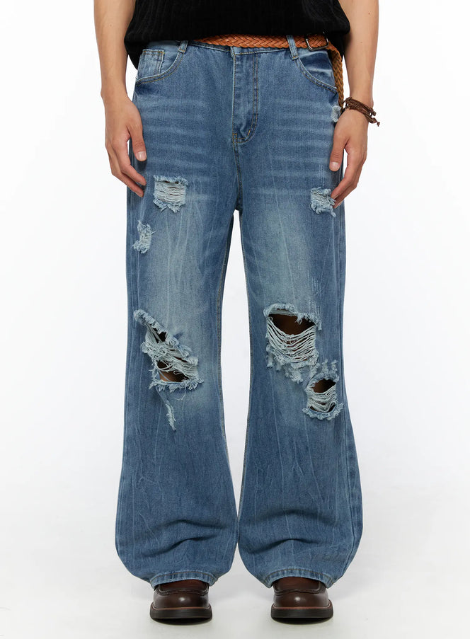 LEWKIN Men's Bryce Ripped Straight-Fit Jeans IL520 Blue front close-up on model showing large distressed knee tears and frayed holes with braided belt
