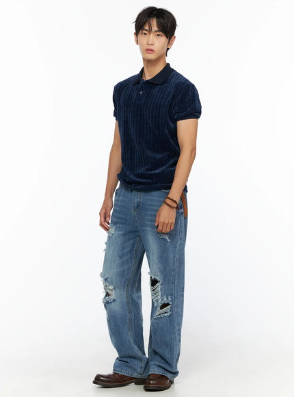 Men's Bryce Ripped Straight-Fit Jeans IL520 Blue three-quarter front view on male model in navy velour polo braided belt brown loafers arms relaxed at sides