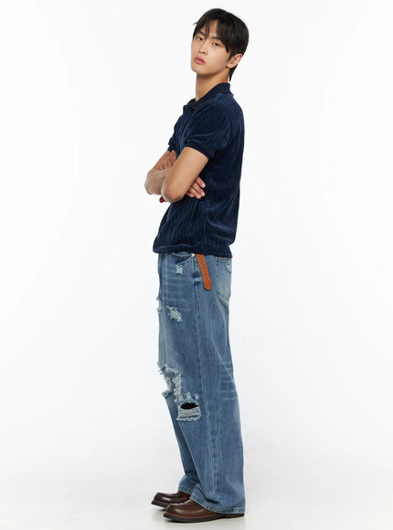 Men's Bryce Ripped Straight-Fit Jeans IL520 Blue full-body side shot on male model arms crossed styled with navy velour polo braided belt brown loafers