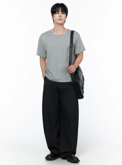 Men's Buckle Crossbody Bag IU523 Black front shot on male model in gray tee and pinstripe trousers wearing bag crossbody standing upright