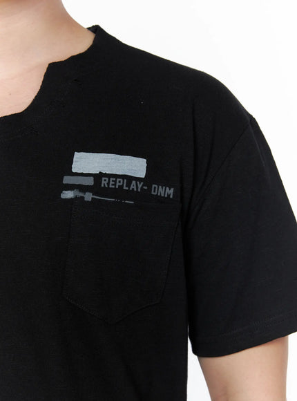Men's Button Detail Logo T-Shirt IL502 Black close-up detail of chest pocket area showing REPLAY-DNM logo print with gray brushstroke graphic and slub cotton fabric texture