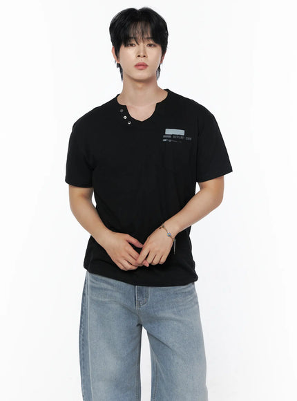 LEWKIN Men's Button Detail Logo T-Shirt IL502 Black front view on model wearing jeans, hands clasped, split V-neck with metal buttons and REPLAY-DNM chest print