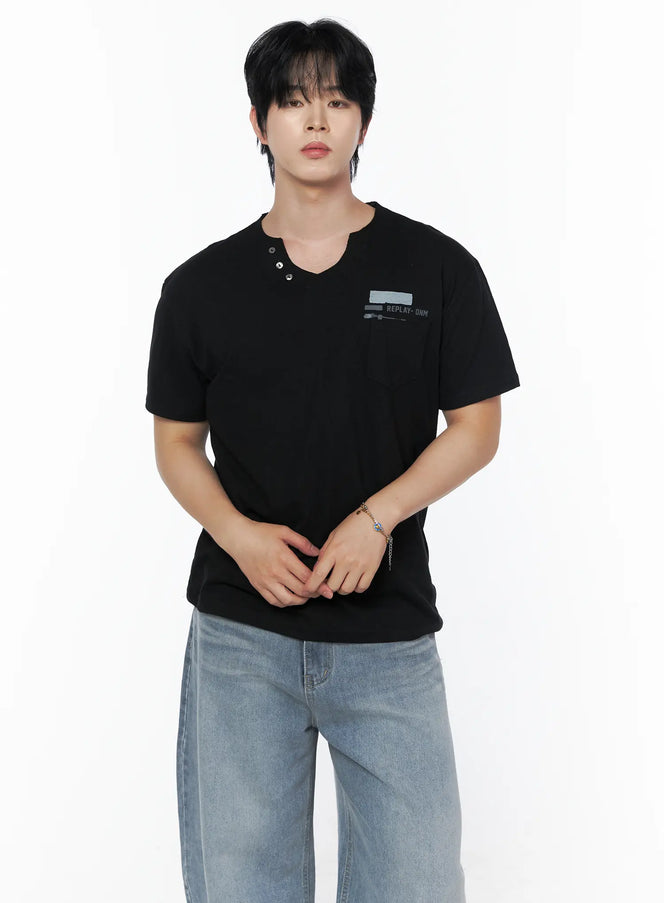 LEWKIN Men's Button Detail Logo T-Shirt IL502 Black front view on model wearing jeans, hands clasped, split V-neck with metal buttons and REPLAY-DNM chest print