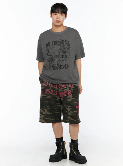 Men's Camo Graphic Sweat Shorts (Dark Green) IL514 Dark green full-body front view on model styled with grey washed oversized tee hands in pockets and black boots