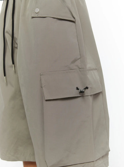 Men's Cargo Bermuda Shorts (Gray) IL509 Gray close-up detail of cargo pocket flap with black toggle clasp and snap-button hip pocket on nylon fabric
