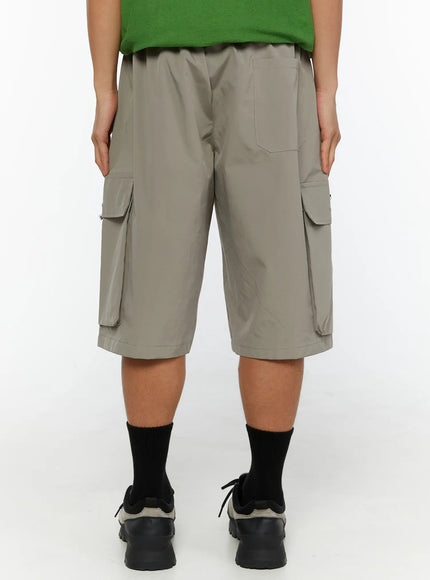 Men's Cargo Bermuda Shorts (Gray) IL509 Gray back view on model showing rear patch pocket, elastic waistband, and bilateral cargo pockets