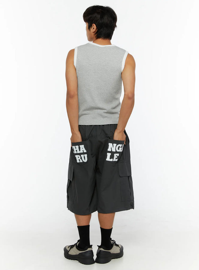 LEWKIN Men's Cargo Jorts IL510 Dark gray back view on male model size M/L hands in pockets showing CHANGE RULE letter print on rear pockets