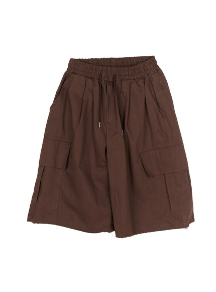Men's Cargo Pocket Jorts IL510 Dark brown flat-lay front view showing elastic drawstring waistband wide-leg silhouette and dual flap cargo pockets on woven fabric