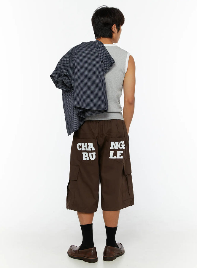 Men's Cargo Pocket Jorts IL510 Dark brown back view on male model wearing gray sleeveless top with plaid shirt draped over shoulder and brown loafers