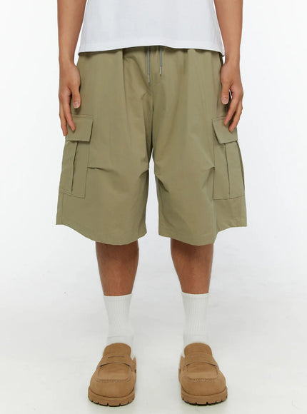 LEWKIN Men's Cargo Shorts IL513 Dark green front view on male model wearing white tee and loafers, elastic drawstring waist, dual flap cargo pockets