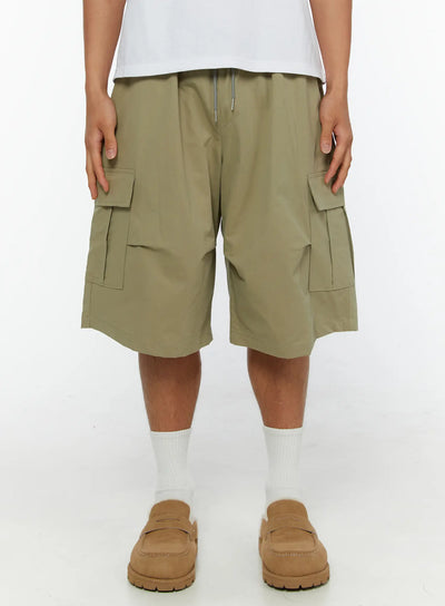 LEWKIN Men's Cargo Shorts IL513 Dark green front view on male model wearing white tee and loafers, elastic drawstring waist, dual flap cargo pockets