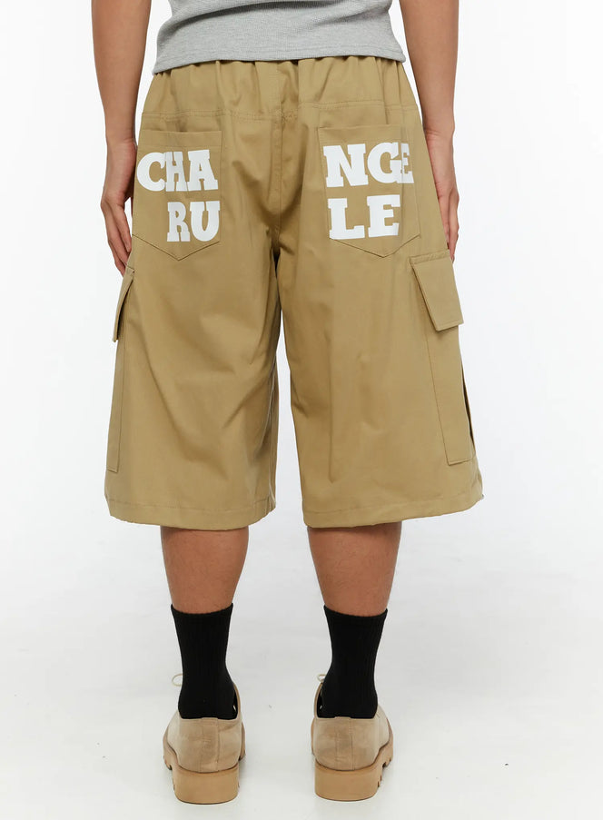 Men's Cargo Street Jorts IL510 khaki back shot on male model standing showing full CHANGE RULE graphic print across rear pockets and side cargo pockets