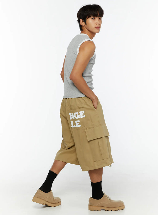LEWKIN Men's Cargo Street Jorts IL510 khaki side-angle shot on male model walking pose showing right-side graphic text print and cargo pocket detail