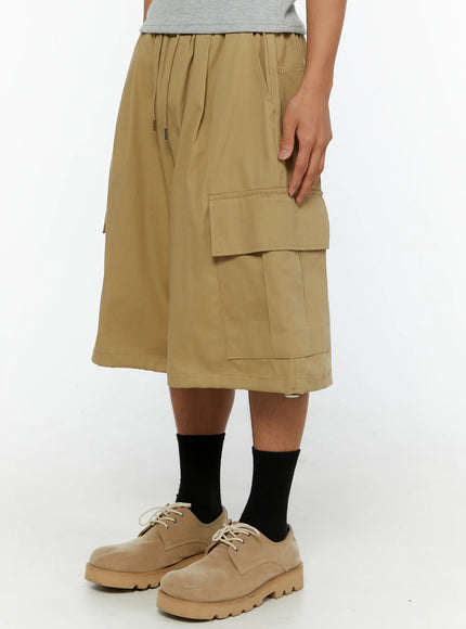 Men's Cargo Street Jorts IL510 khaki right-side close-up shot on male model showing side cargo pocket detail elastic waistband and partial CHANGE RULE graphic