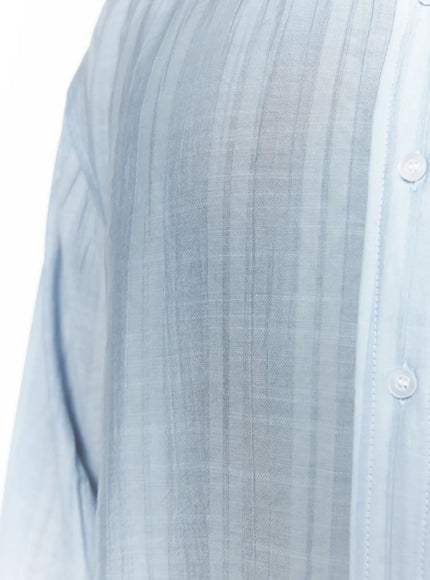 Men's Casual Button-Up Shirt IL502 Light blue close-up fabric detail showing tonal vertical stripe weave pattern, semi-sheer lightweight texture, and white button placket