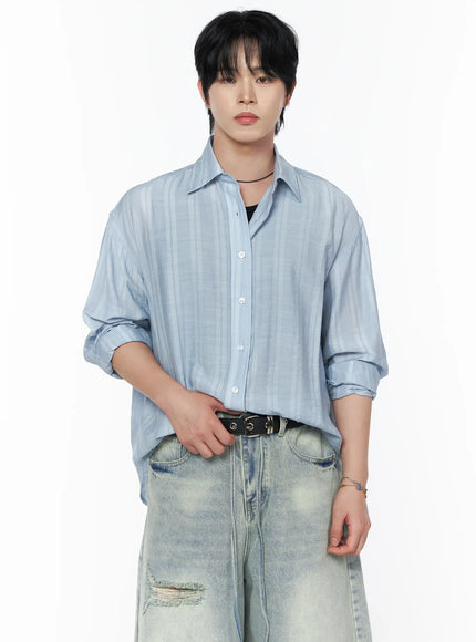 Men's Casual Button-Up Shirt IL502 Light blue cropped front view on model with hands at belt, showing tonal stripe weave, white buttons, and rolled sleeves over jeans