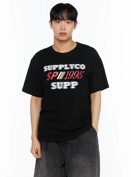 Men's Casual Graphic Tee IL514 Black front close-up shot on male model showing oversized fit and SUPPLYCO SP1995 SUPP graphic print on chest