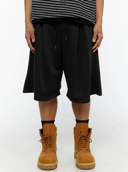 LEWKIN Men's Casual Jorts IL510 Black front crop shot on model wearing striped top and tan boots showing wide-leg silhouette and drawstring waist
