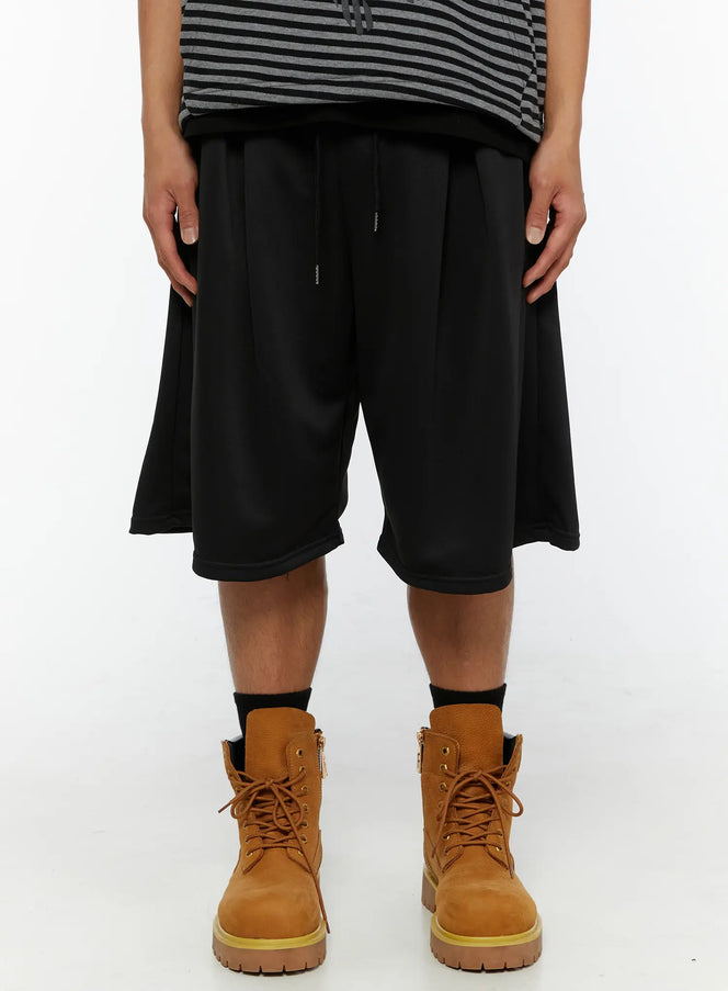 LEWKIN Men's Casual Jorts IL510 Black front crop shot on model wearing striped top and tan boots showing wide-leg silhouette and drawstring waist